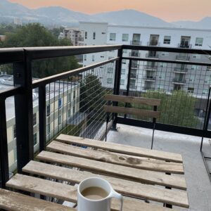 cup of coffee on a table on merideth's balcony with mountain views in the background