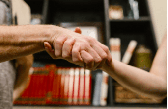 close up of man and woman's hands intertwined